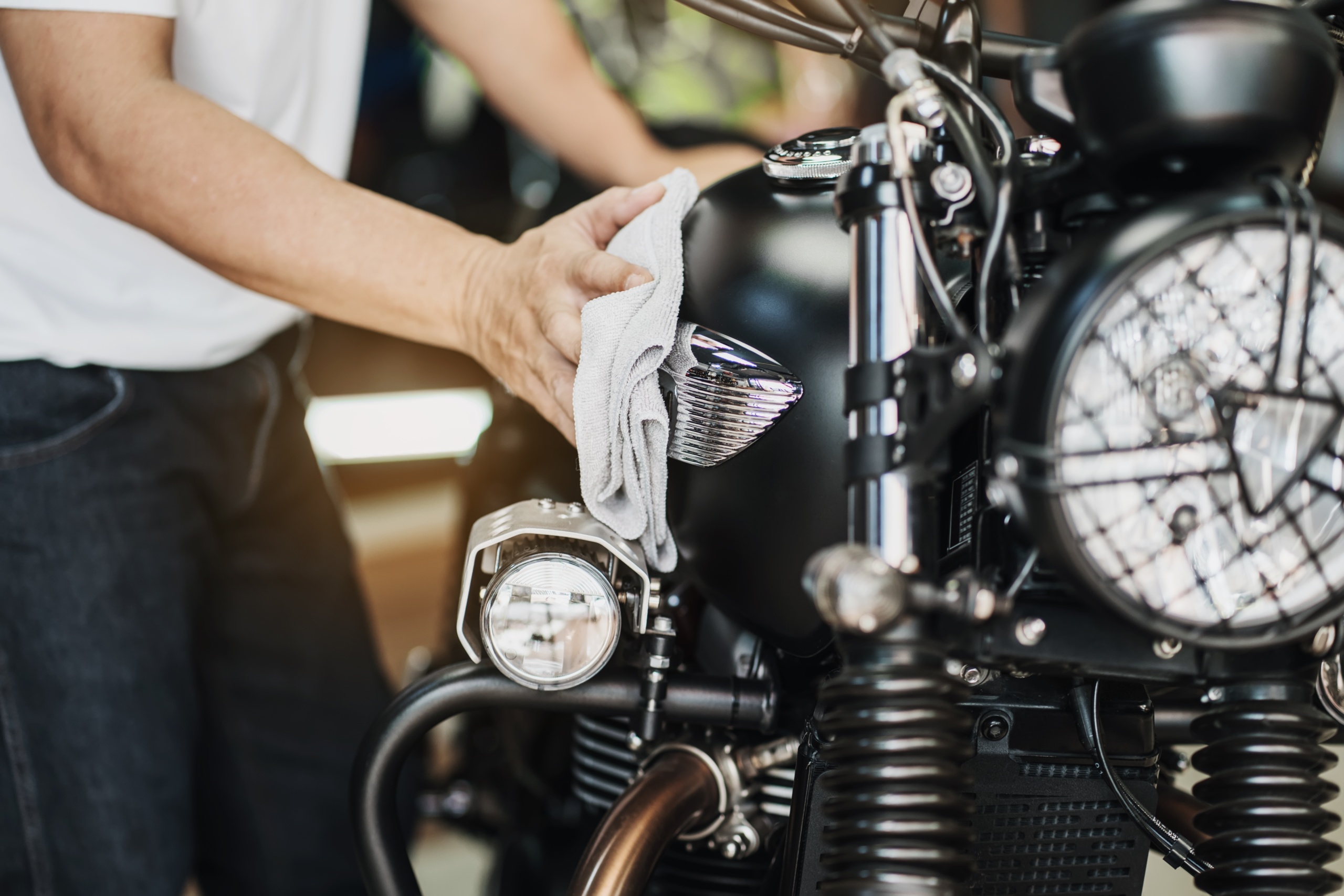 biker,man,cleaning,motorcycle,,,polished,and,coating,wax,on